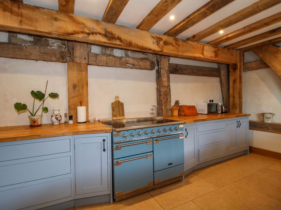 A kitchen with a stove and microwave at Crook Barn in Tenbury Wells