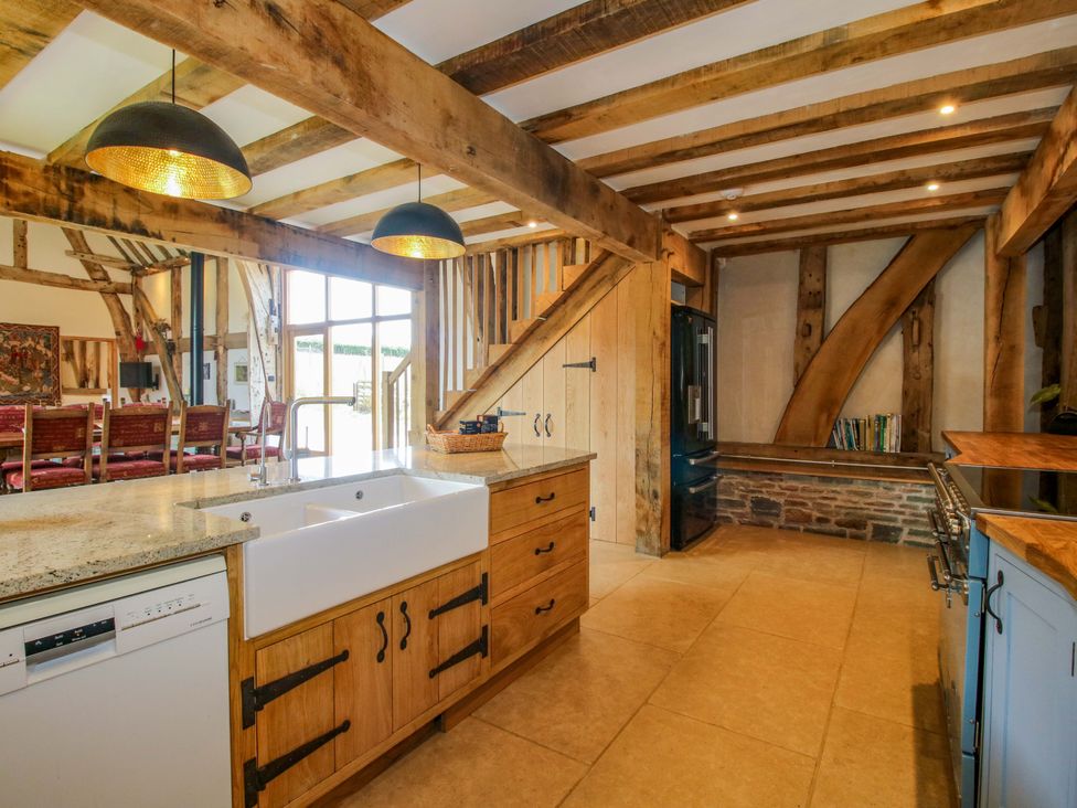 A kitchen with a sink and refrigerator at Crook Barn Tenbury Wells