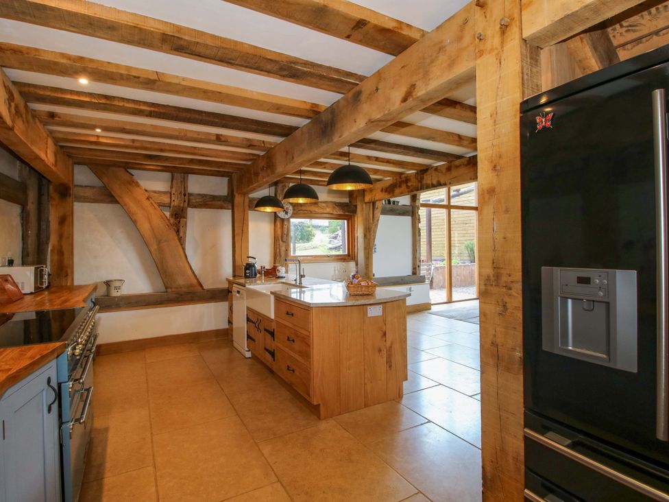 A kitchen with an island and appliances at Crook Barn in Tenbury Wells