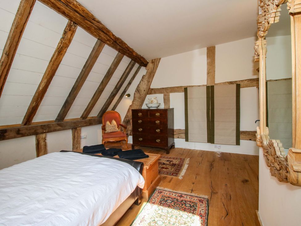 A bedroom with bed and furniture at Crook Barn Tenbury Wells