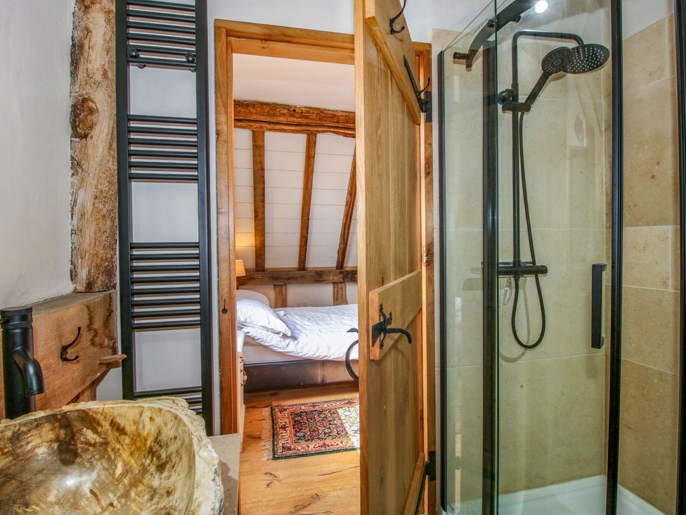 A bathroom with a shower and sink at Crook Barn, Tenbury Wells