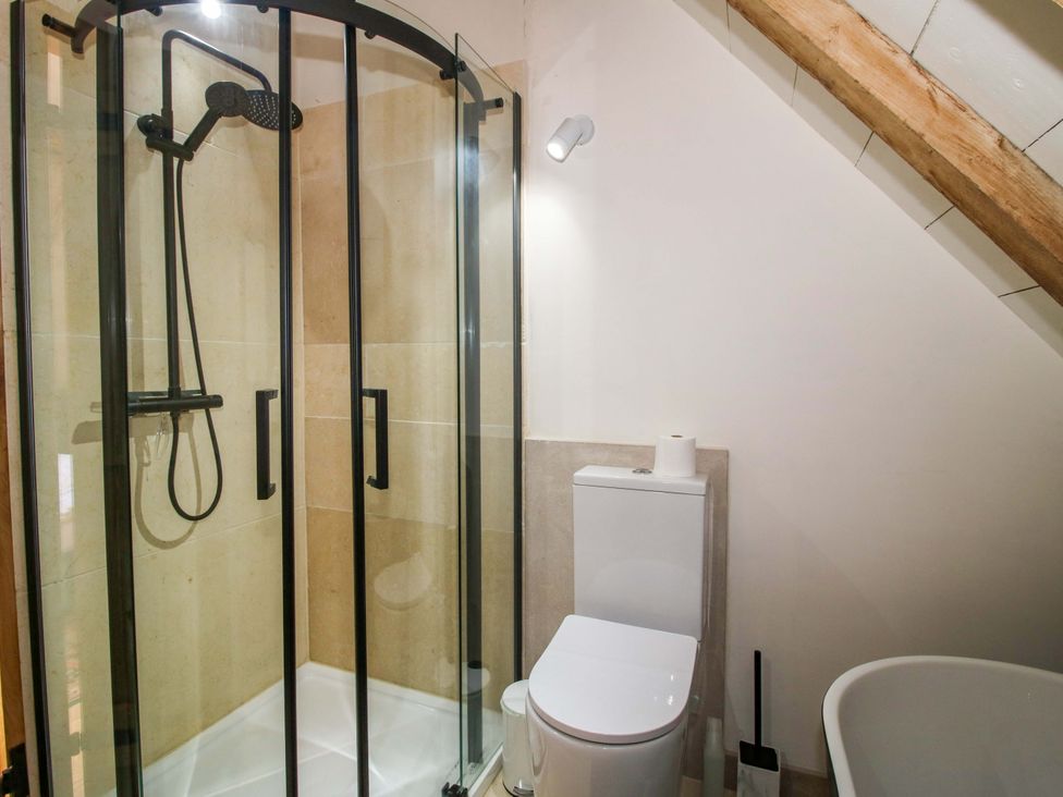 A bathroom with a shower and toilet at Crook Barn in Tenbury Wells