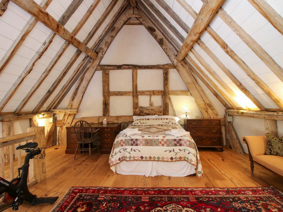 A bedroom with a bed and nightstand at Crook Barn in Tenbury Wells