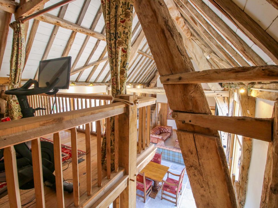 A loft with an exercise bike and a seating area at Crook Barn Tenbury Wells