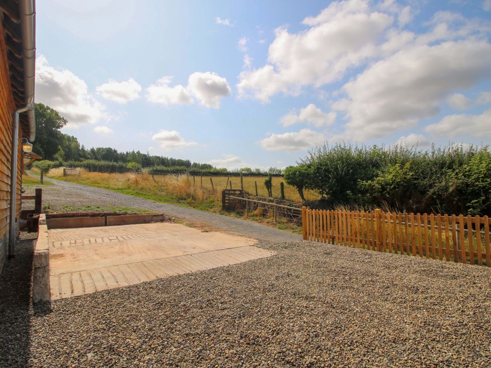 An outdoor view with gravel and a wooden fence at Crook Barn Tenbury Wells