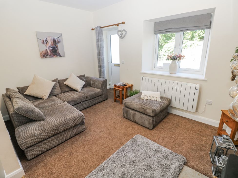 A living room with a sofa and coffee table at Vern Dale in Builth Wells