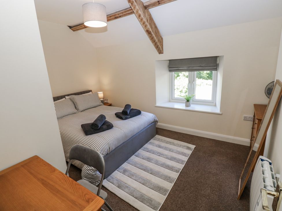 A bedroom with a bed and window at Vern Dale in Builth Wells