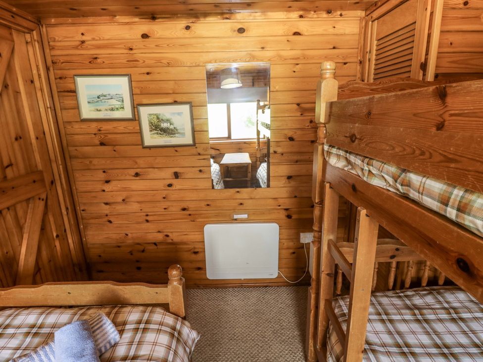 A bedroom with a bunk bed and twin bed at Oak Lodge Mynydd Cerrig near Porthyrhyd