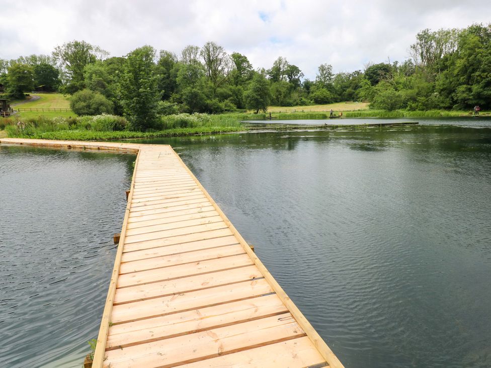 A wooden dock extending into a water body at Oak Lodge in Mynydd Cerrig near Porthyrhyd