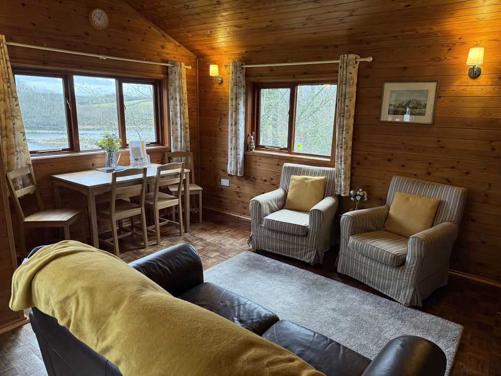 A living room with a table and chairs at Ash Lodge in Mynydd Cerrig near Porthyrhyd