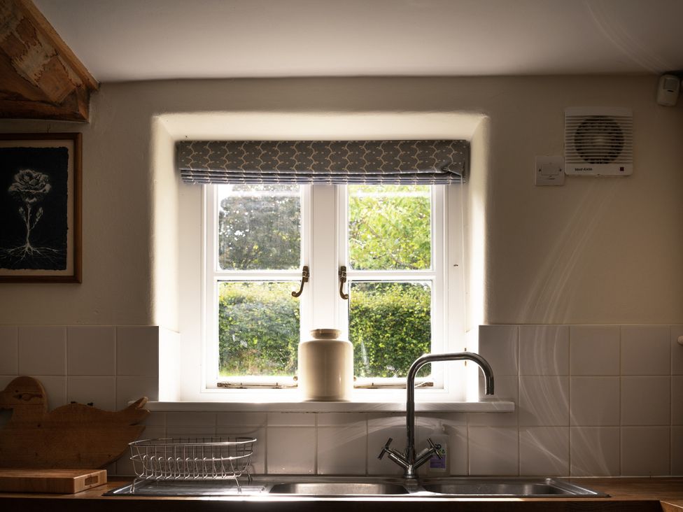 A kitchen with a window and sink at West Cottage Llandovery