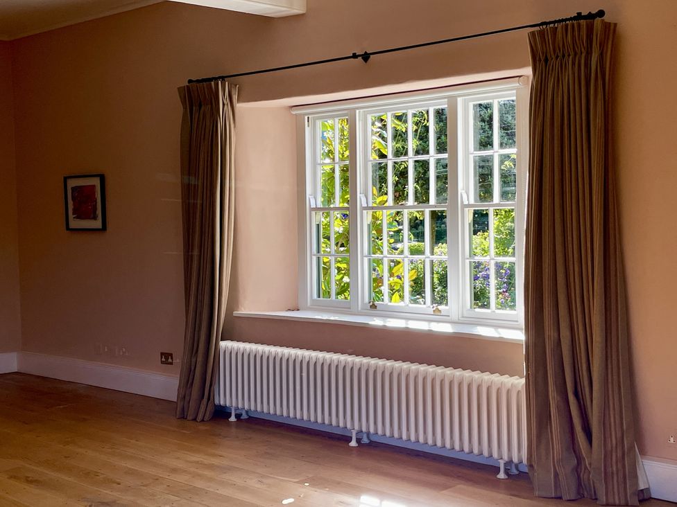 A living room with a window and radiator at West Cottage in Myddfai near Llandovery