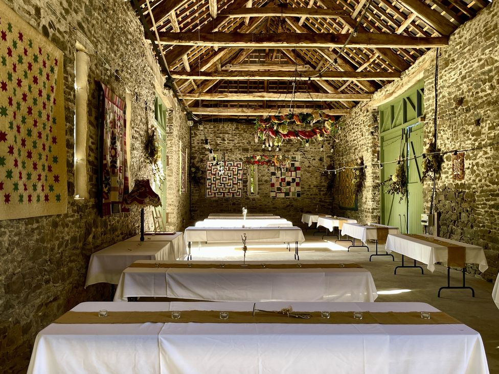 A dining hall with tables and decorations at West Cottage Myddfai near Llandovery