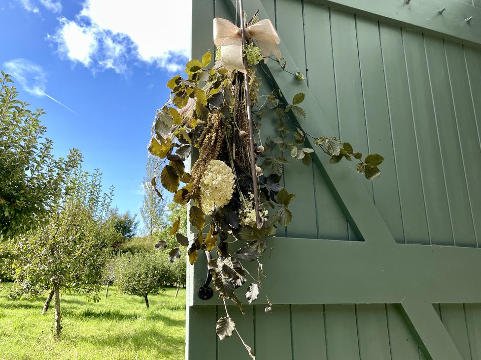 A hanging decoration with dried flowers on a green door at West Cottage Myddfai near Llandovery
