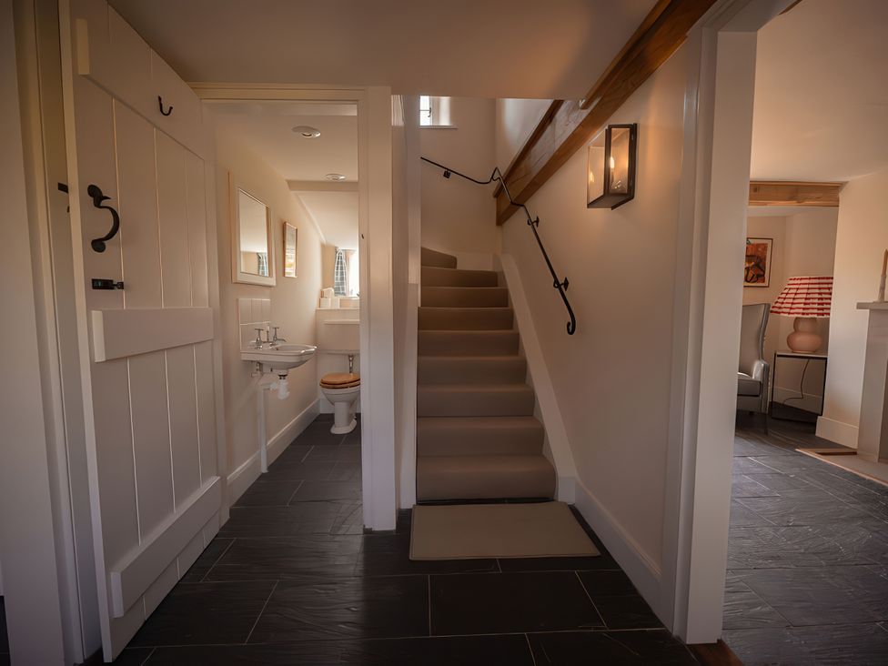 A hallway with a staircase and a toilet at West Cottage Myddfai near Llandovery