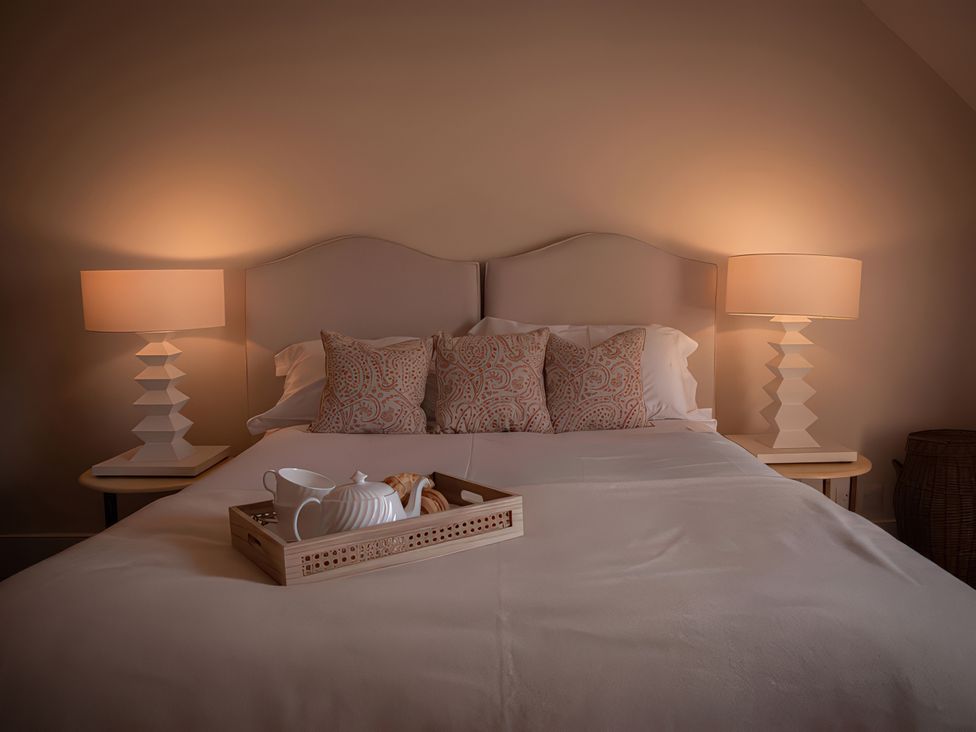 A bedroom with a bed and bedside tables at West Cottage near Llandovery