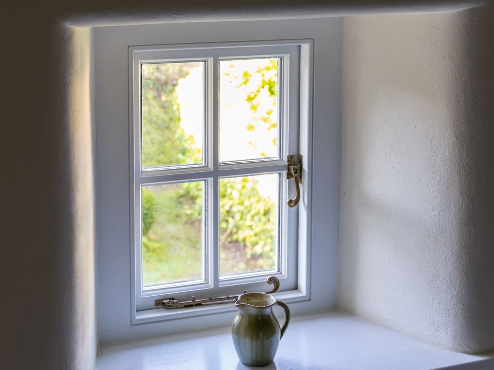 A window with a jug on the sill at West Cottage in Myddfai near Llandovery