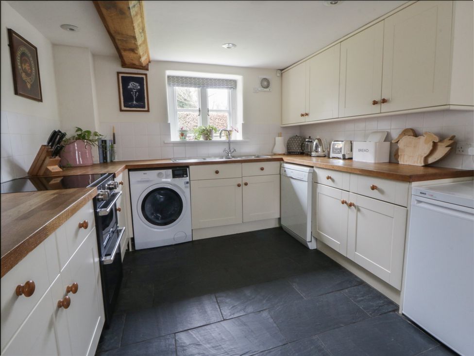 A kitchen with appliances and cabinetry at West Cottage Myddfai near Llandovery