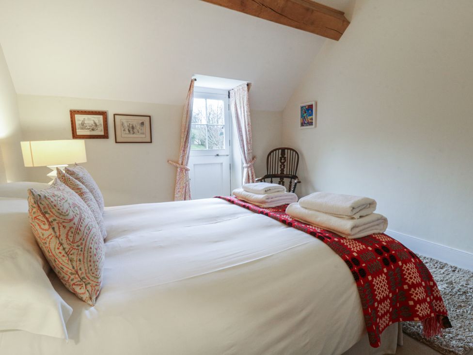A bedroom with double bed and side table at West Cottage in Myddfai near Llandovery