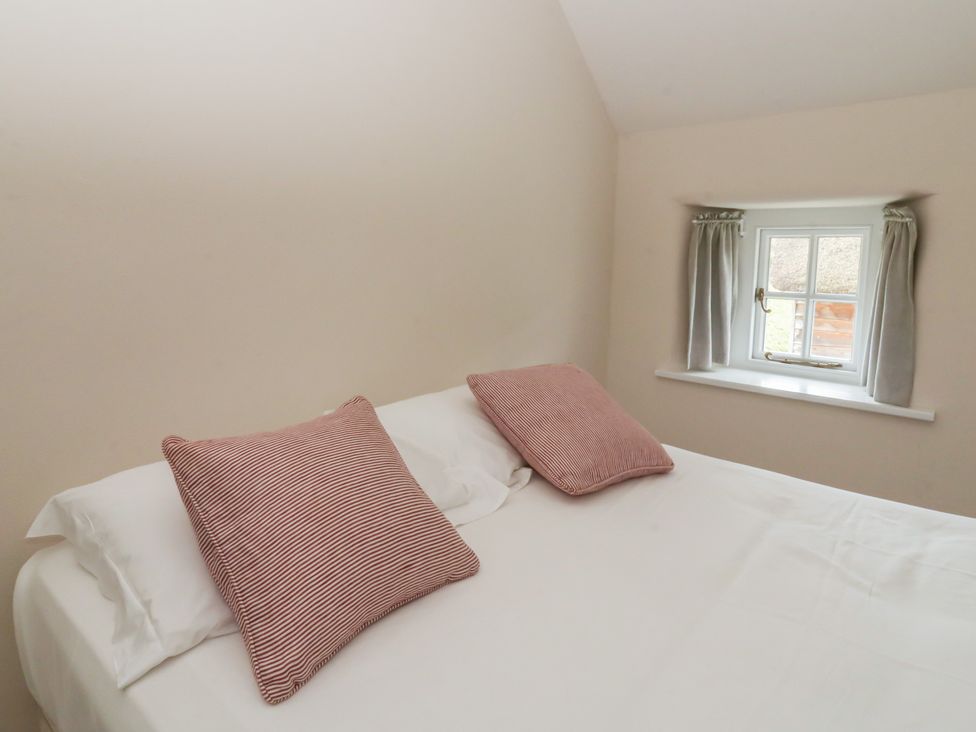 A bedroom with a bed and pillows at Gatekeepers Cottage Myddfai near Llandovery