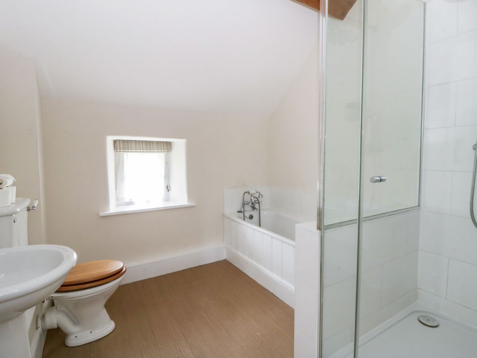 A bathroom with a bathtub and shower at Gatekeepers Cottage Myddfai near Llandovery