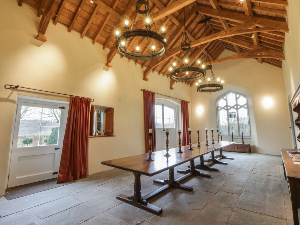 A dining room with a long table and chairs at Gatekeepers Cottage Myddfai near Llandovery
