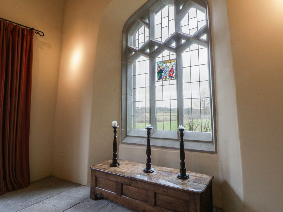 An interior view with a window and candles at Gatekeepers Cottage Myddfai near Llandovery