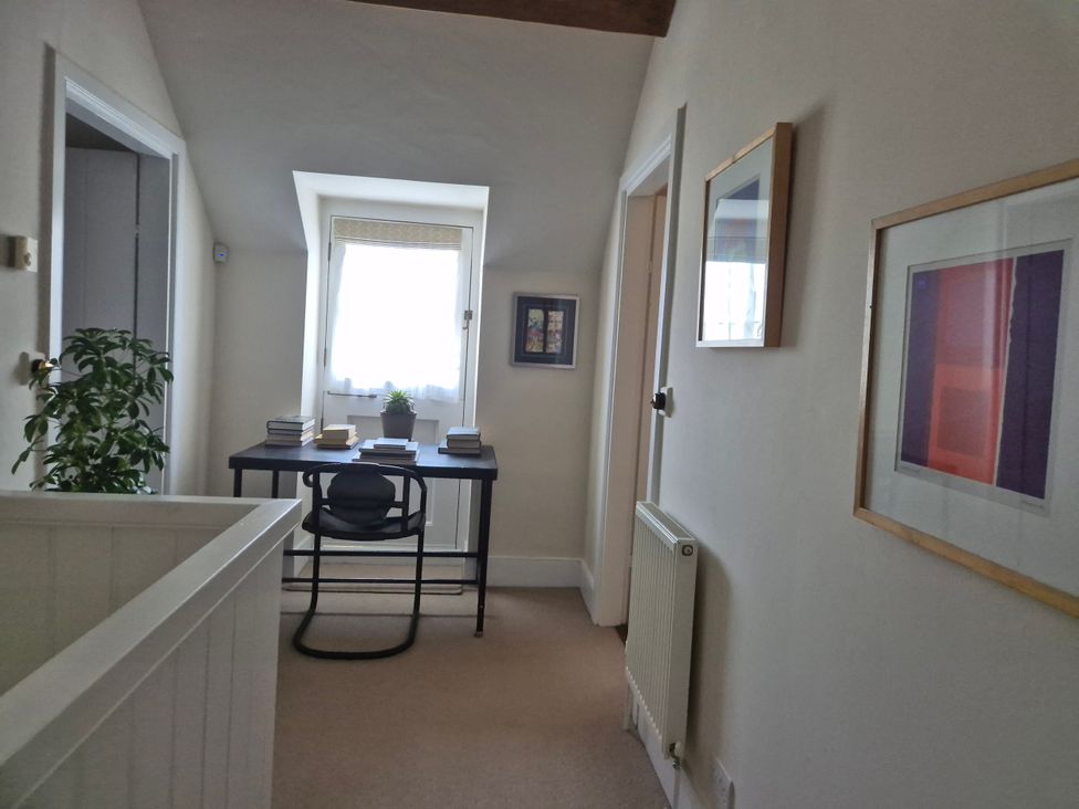 A hallway with a desk and chair at Gatekeepers Cottage Myddfai near Llandovery