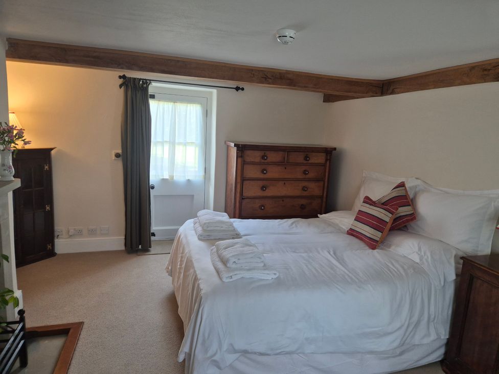 A bedroom with a bed and chest of drawers at Gatekeepers Cottage in Myddfai near Llandovery