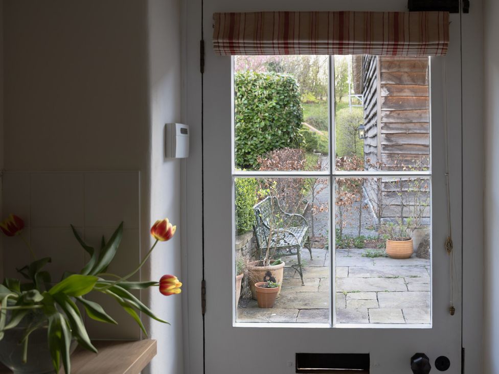 A kitchen with a view of a garden from a door at Gatekeepers Cottage Myddfai near Llandovery