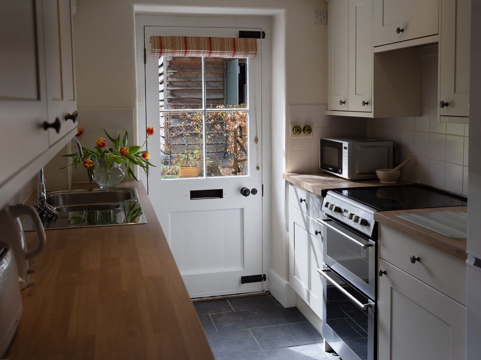 A kitchen with a sink and oven at Gatekeepers Cottage in Myddfai near Llandovery