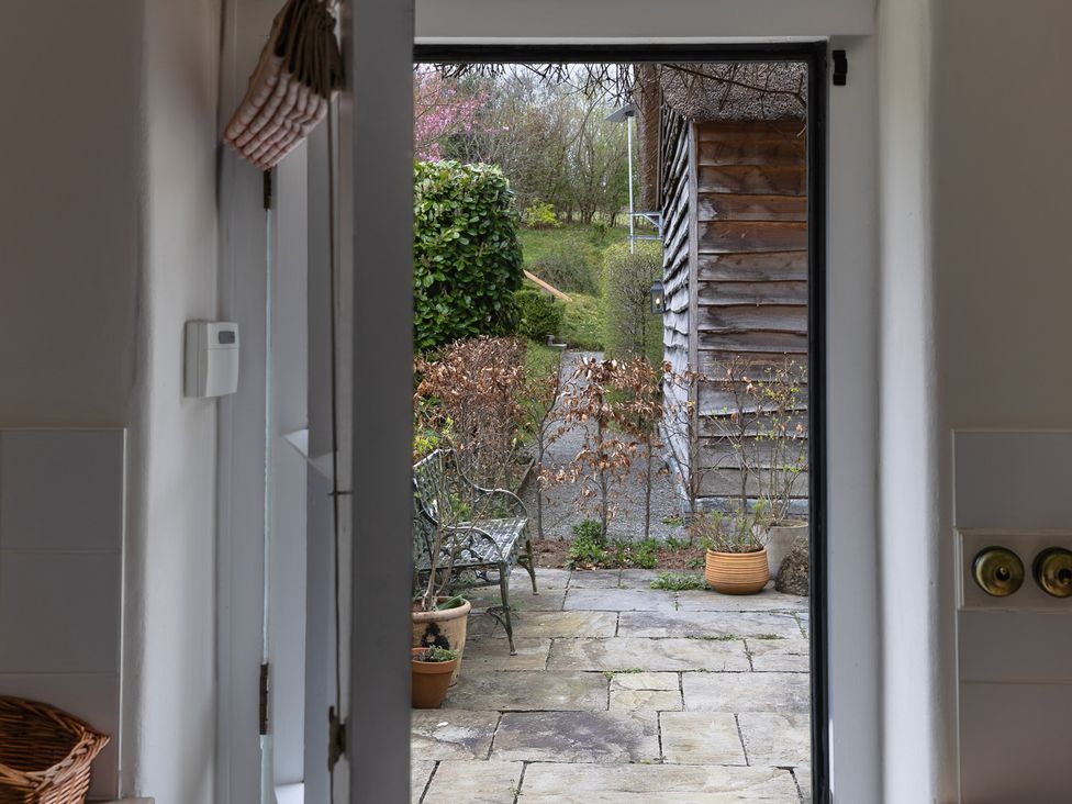A view from a kitchen door showing a patio and garden at Gatekeepers Cottage Myddfai near Llandovery