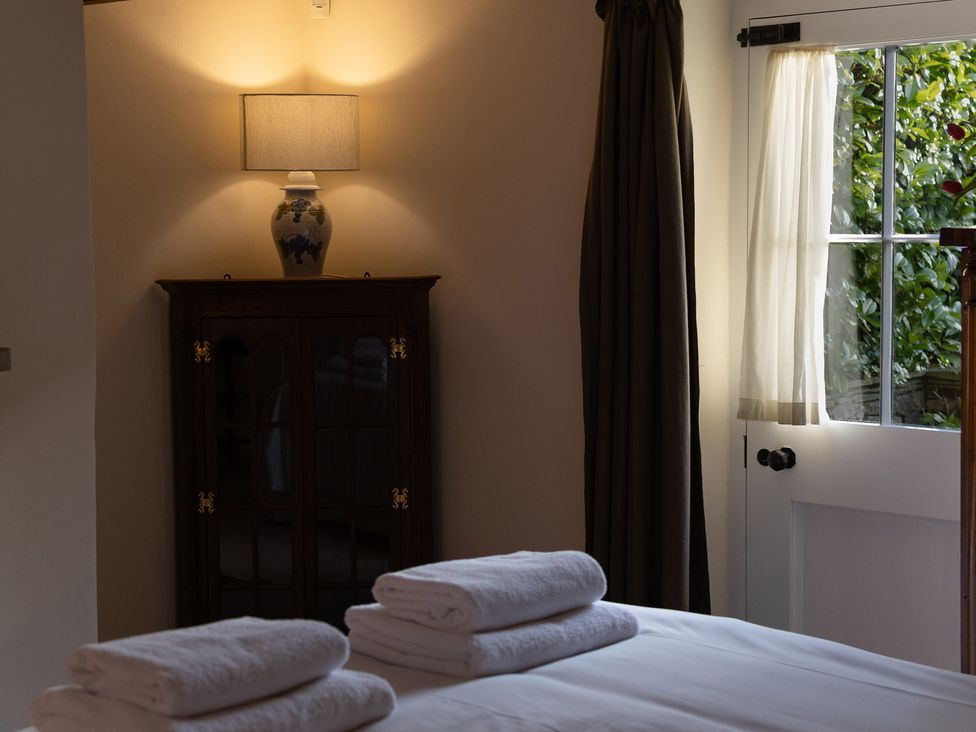 A bedroom with towels on a bed at Gatekeepers Cottage Myddfai near Llandovery