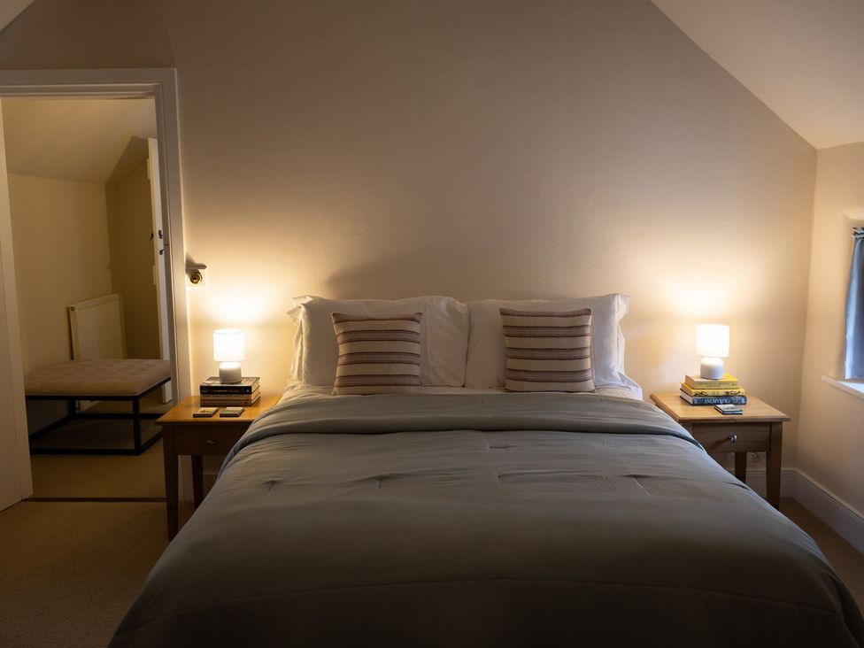 A bedroom with a bed and lamps at Gatekeepers Cottage in Myddfai near Llandovery