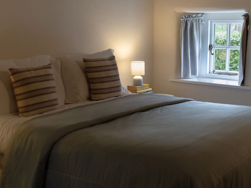 A bedroom with a bed and lamp at Gatekeepers Cottage Myddfai near Llandovery