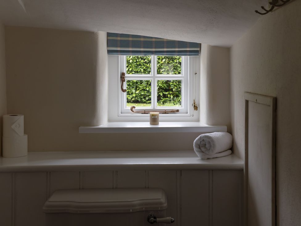 A bathroom with a window and a towel at Gatekeepers Cottage, Myddfai near Llandovery