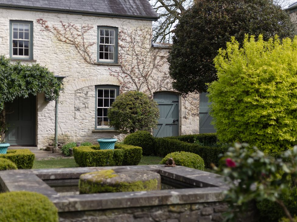 A stone house with two doors and windows in the garden at Gatekeepers Cottage Myddfai near Llandovery