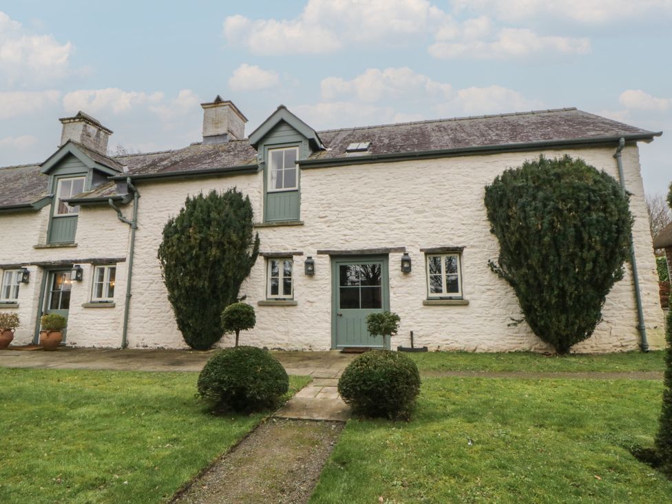 A house with shrubs and a pathway at North Cottage Llandovery