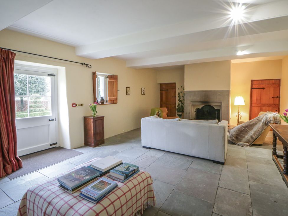A living room with a sofa and fireplace at North Cottage in Llandovery