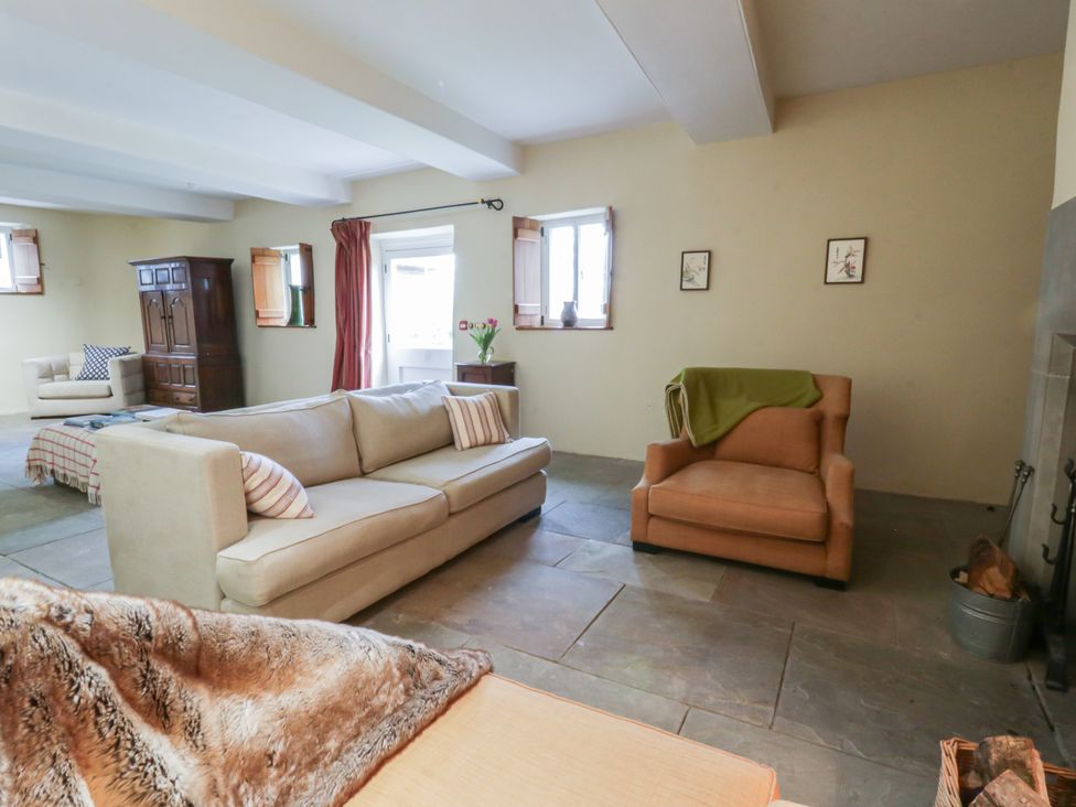 A living room with a sofa and armchair at North Cottage in Llandovery