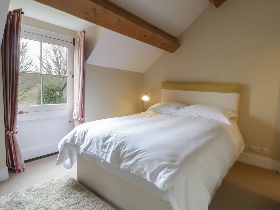 A bedroom with a bed and window at North Cottage Llandovery