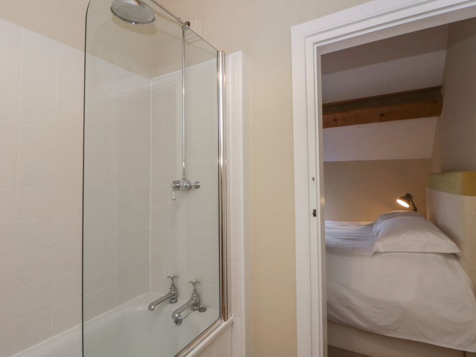 A bathroom with a shower and a view of a bedroom at North Cottage in Llandovery