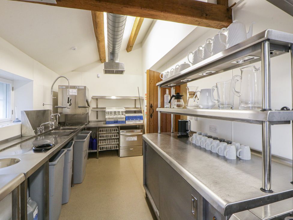 A kitchen with stainless steel fixtures and shelving at North Cottage in Llandovery