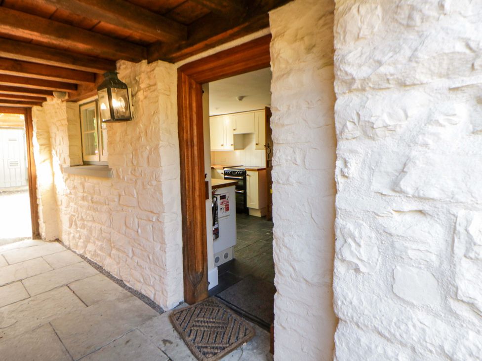 A hallway with a view into the kitchen at North Cottage in Myddfai near Llandovery