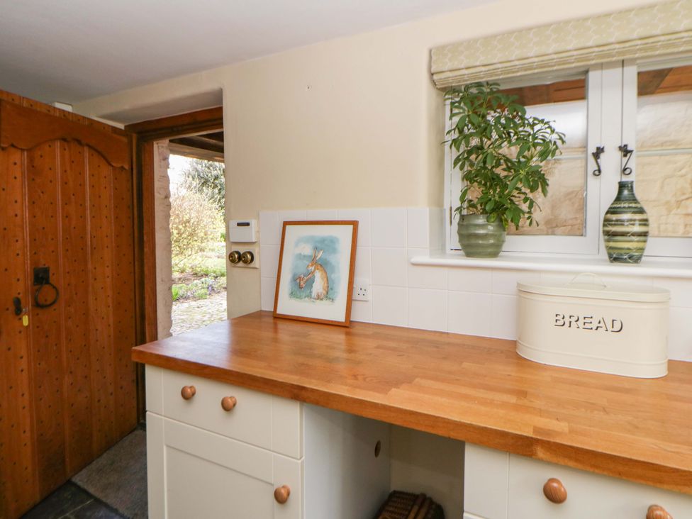 A kitchen with a wooden countertop and a door at North Cottage Myddfai near Llandovery