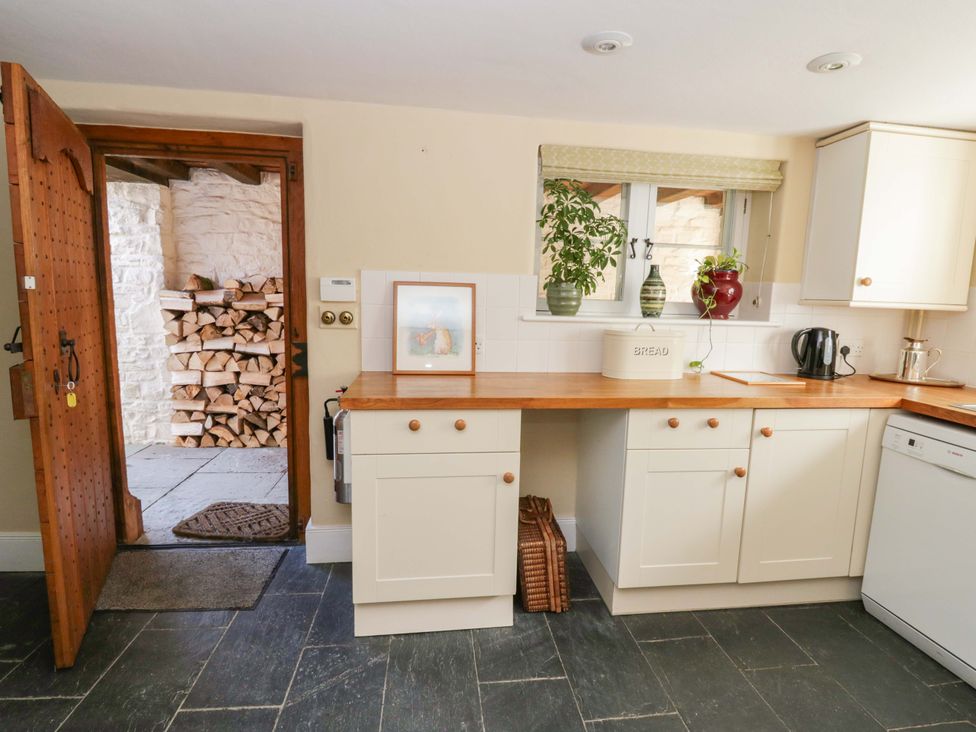 A kitchen with a wooden countertop and appliances at North Cottage Myddfai near Llandovery