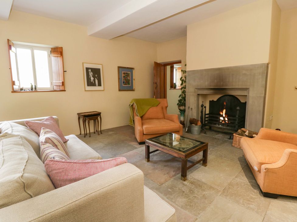 A living room with a fireplace and seating at North Cottage Myddfai near Llandovery