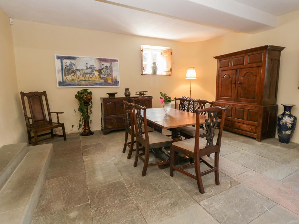 A dining room with a wooden table and chairs at North Cottage Myddfai near Llandovery