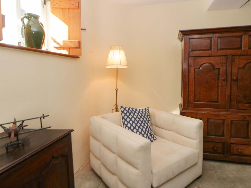 A living room with a chair and lamp at North Cottage Myddfai near Llandovery