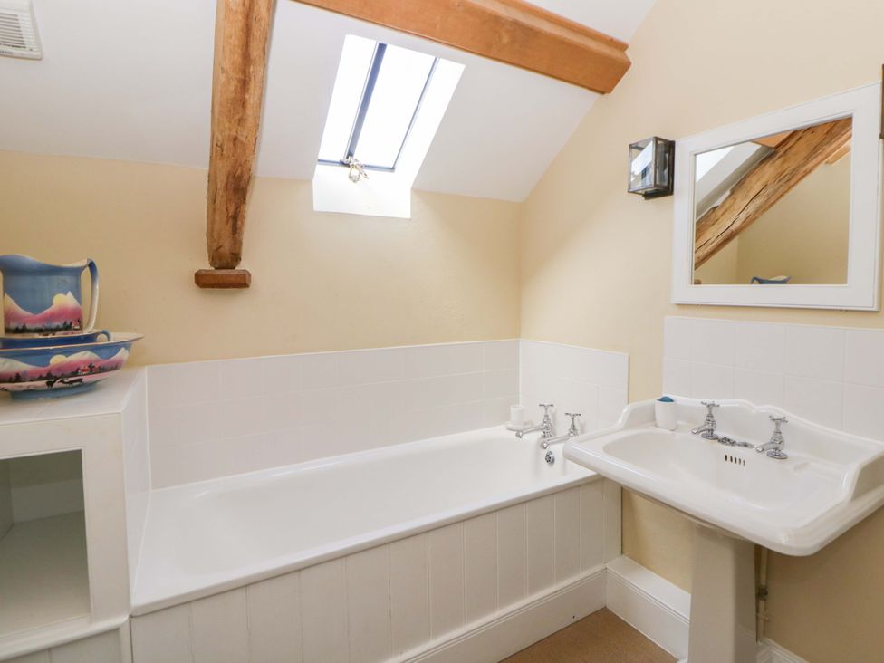 A bathroom with a bath tub and sink at North Cottage near Myddfai near Llandovery